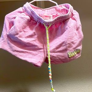 1 short-xs barbie logo on corner. 1 pair of size 7 Barbie shoe and one hoodie-s